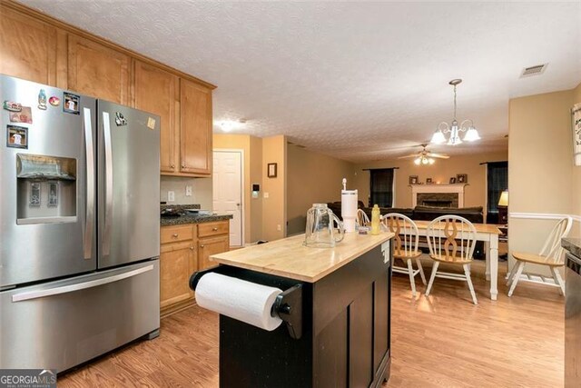 3265 Watson Gate Rd, Loganville, GA 30052 - kitchen with stainless steel fridge with ice dispenser, light wood-style flooring, butcher block countertops, a chandelier, and pendant lighting