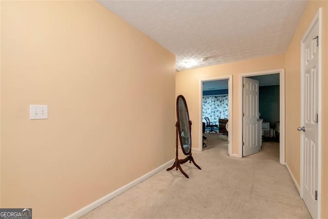 3265 Watson Gate Rd, Loganville, GA 30052 - hallway with light carpet, a textured ceiling, and baseboards