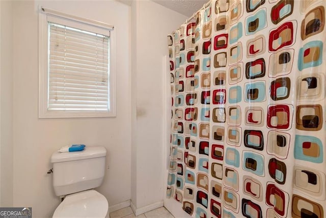 3265 Watson Gate Rd, Loganville, GA 30052 - full bathroom with a shower with curtain, toilet, baseboards, and tile patterned flooring