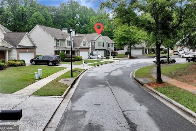 3265 Watson Gate Rd, Loganville, GA 30052 - view of asphalt street with curbs, a residential view, and sidewalks