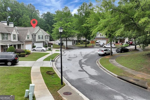 3265 Watson Gate Rd, Loganville, GA 30052 - view of asphalt street featuring a residential view, curbs, street lighting, and sidewalks
