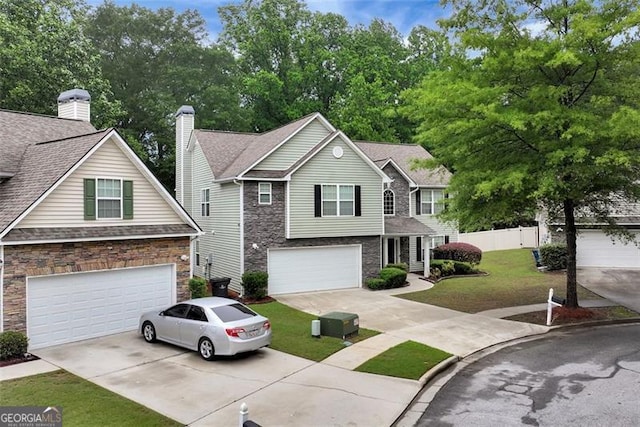3265 Watson Gate Rd, Loganville, GA 30052 - view of front of home with concrete driveway, an attached garage, and stone siding