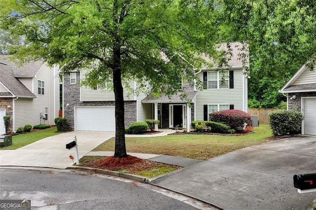 3265 Watson Gate Rd, Loganville, GA 30052 - view of front facade with driveway, stone siding, and an attached garage