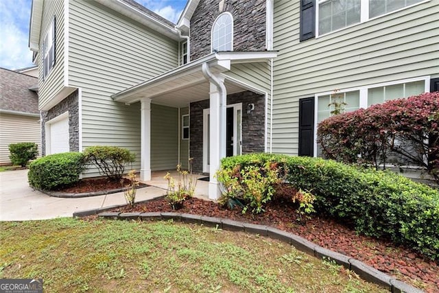 3265 Watson Gate Rd, Loganville, GA 30052 - doorway to property featuring covered porch and stone siding