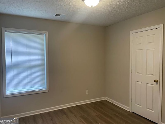 248 Dreamland Cir, Winder, GA 30680 - unfurnished room featuring dark wood-style flooring, a textured ceiling, and baseboards
