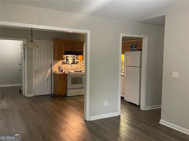 248 Dreamland Cir, Winder, GA 30680 - kitchen with white appliances, dark wood-style floors, baseboards, and under cabinet range hood