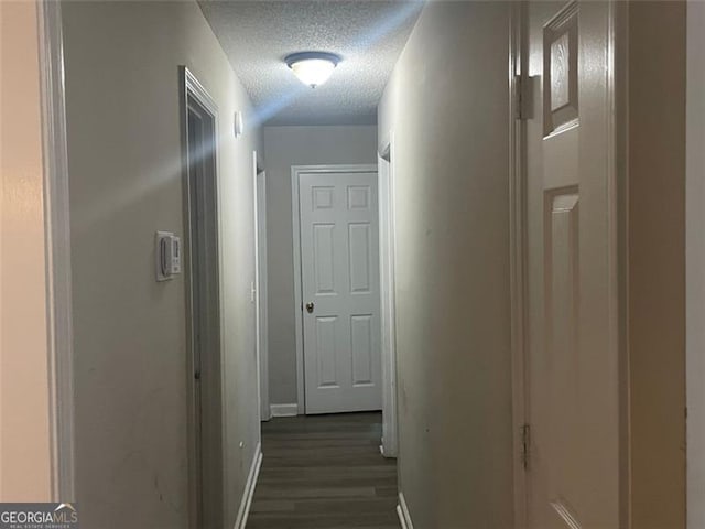 248 Dreamland Cir, Winder, GA 30680 - hallway with a textured ceiling, dark wood finished floors, and baseboards