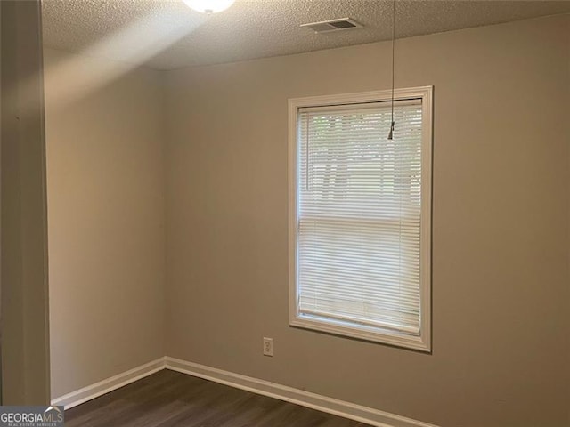 248 Dreamland Cir, Winder, GA 30680 - spare room featuring dark wood-style flooring, baseboards, and a textured ceiling