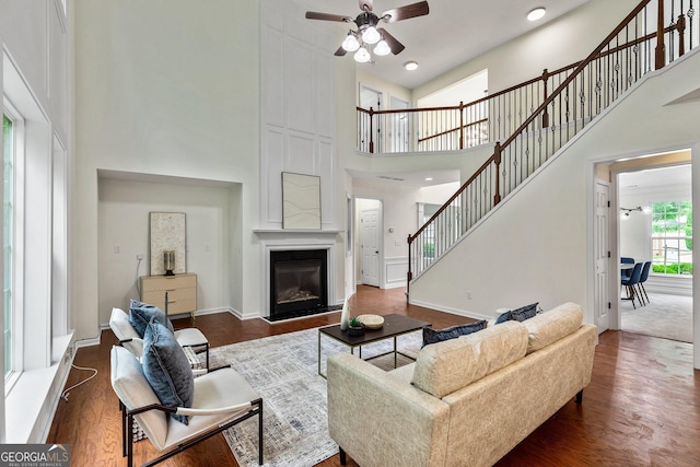 3153 Daleview Way SW, Atlanta, GA 30331 - living room with a high ceiling, ceiling fan, dark wood finished floors, stairway, and a large fireplace