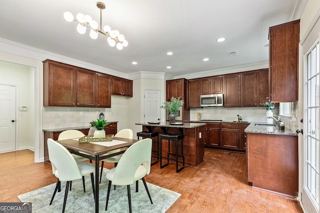 3153 Daleview Way SW, Atlanta, GA 30331 - dining space featuring light wood-style flooring, crown molding, recessed lighting, and healthy amount of natural light
