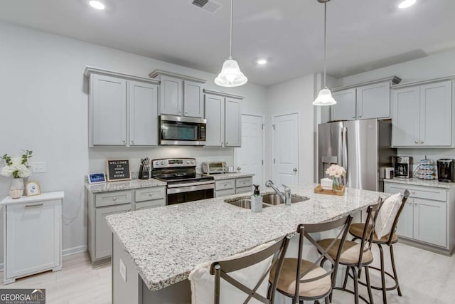 3426 Abbey Way, Gainesville, GA 30507 - kitchen with stainless steel appliances, a sink, gray cabinets, a kitchen breakfast bar, and recessed lighting