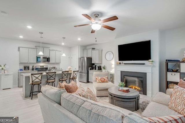 3426 Abbey Way, Gainesville, GA 30507 - living area with a ceiling fan, recessed lighting, a glass covered fireplace, light wood finished floors, and baseboards