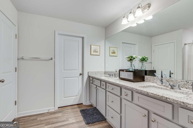 3426 Abbey Way, Gainesville, GA 30507 - bathroom with wood finished floors, double vanity, and baseboards