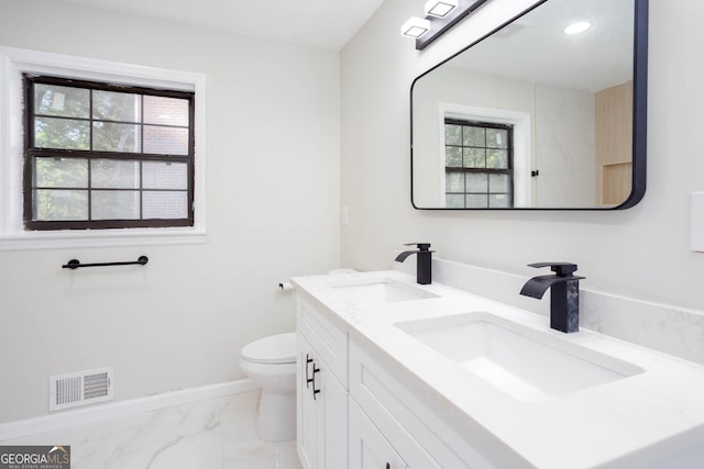 3193 Trasher Cir, Decatur, GA 30032 - bathroom featuring marble look tile flooring, toilet, double vanity, and baseboards