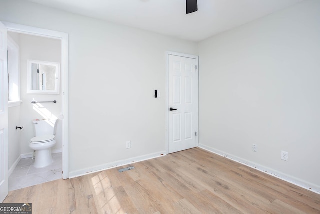 3193 Trasher Cir, Decatur, GA 30032 - unfurnished bedroom with wood finished floors, baseboards, ensuite bathroom, and ceiling fan