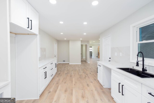3193 Trasher Cir, Decatur, GA 30032 - kitchen featuring a sink, light wood-style flooring, white cabinets, recessed lighting, and light countertops