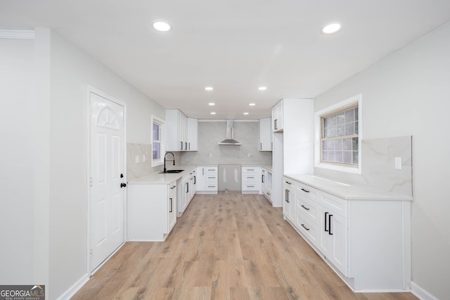 3193 Trasher Cir, Decatur, GA 30032 - kitchen featuring a sink, wall chimney exhaust hood, recessed lighting, decorative backsplash, and light wood-type flooring