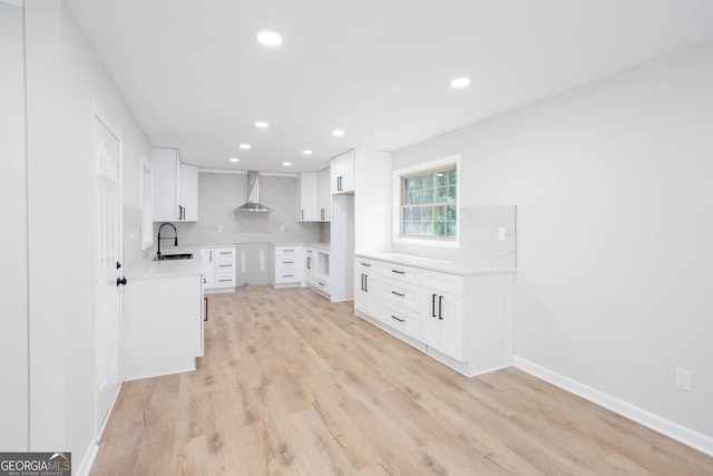 3193 Trasher Cir, Decatur, GA 30032 - kitchen featuring wall chimney exhaust hood, a sink, recessed lighting, light wood-type flooring, and tasteful backsplash