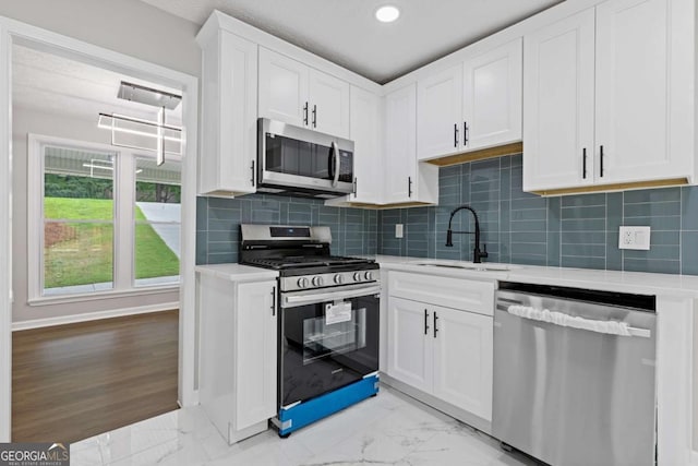 4657 Lou Ivy Rd, Peachtree Corners, GA 30096 - kitchen with appliances with stainless steel finishes, a sink, light countertops, light marble finish floors, and recessed lighting