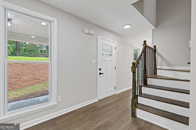 4657 Lou Ivy Rd, Peachtree Corners, GA 30096 - entryway featuring healthy amount of natural light, wood finished floors, baseboards, and stairway