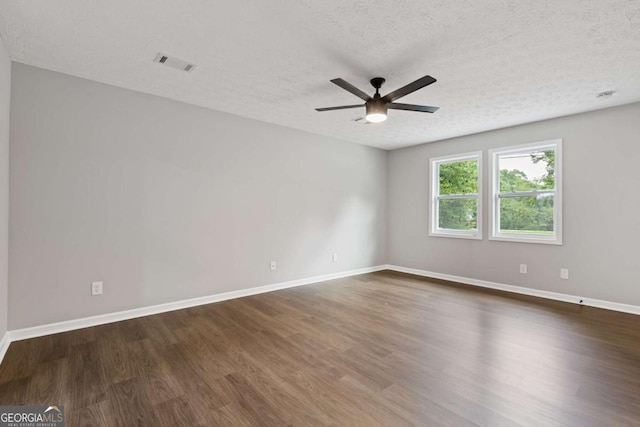 4657 Lou Ivy Rd, Peachtree Corners, GA 30096 - unfurnished room featuring dark wood-type flooring, a ceiling fan, a textured ceiling, and baseboards