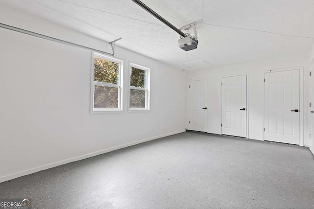 4657 Lou Ivy Rd, Peachtree Corners, GA 30096 - garage featuring a garage door opener and baseboards