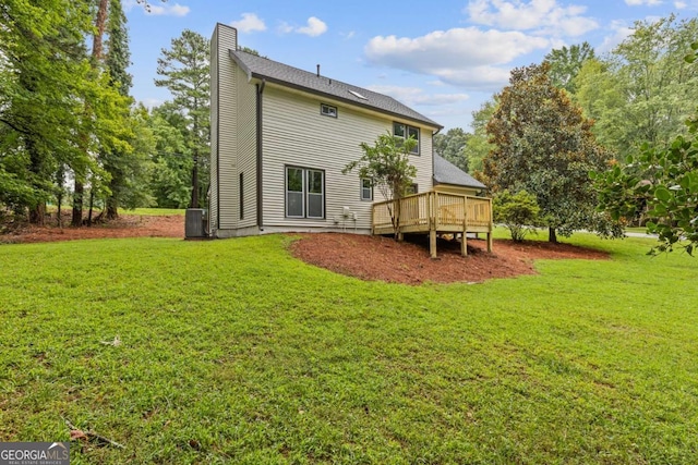 4657 Lou Ivy Rd, Peachtree Corners, GA 30096 - back of property featuring a chimney, a wooden deck, a lawn, and central AC unit