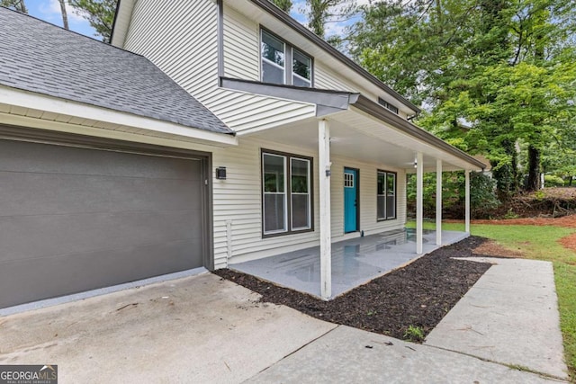 4657 Lou Ivy Rd, Peachtree Corners, GA 30096 - property entrance featuring a porch, roof with shingles, and a garage