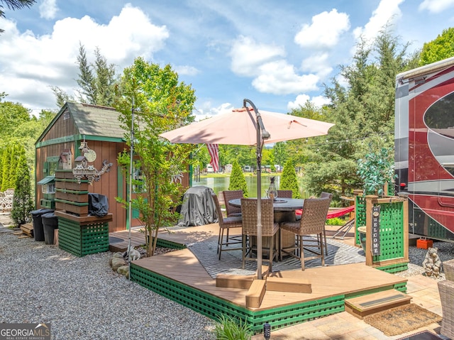 344 Choestoe Falls Cir, Blairsville, GA 30512 - view of patio / terrace with an outdoor structure, outdoor dining space, a storage unit, and a wooden deck