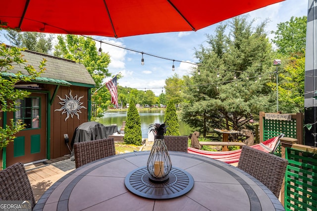 344 Choestoe Falls Cir, Blairsville, GA 30512 - view of patio with outdoor dining area, a water view, and an outdoor structure