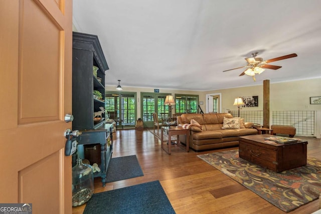 living room with wood finished floors and ceiling fan