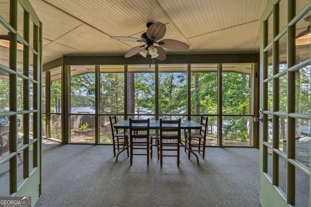 sunroom / solarium with ceiling fan, a water view, and plenty of natural light