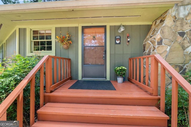doorway to property with board and batten siding and covered porch