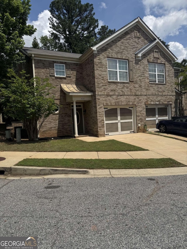 7055 Blairs View Dr Unit 1, Austell, GA 30168 - traditional-style home featuring an attached garage, driveway, and brick siding
