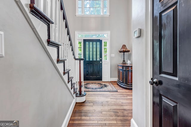 4250 Edgewater Ct NW, Kennesaw, GA 30144 - entrance foyer with hardwood / wood-style flooring, stairway, baseboards, and a high ceiling