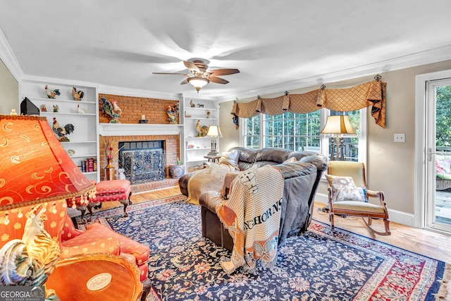 4250 Edgewater Ct NW, Kennesaw, GA 30144 - living area featuring crown molding, ceiling fan, wood finished floors, baseboards, and a fireplace