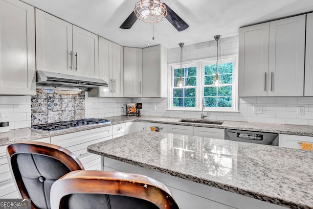 4250 Edgewater Ct NW, Kennesaw, GA 30144 - kitchen with under cabinet range hood, dishwashing machine, stainless steel gas stovetop, a sink, and a ceiling fan