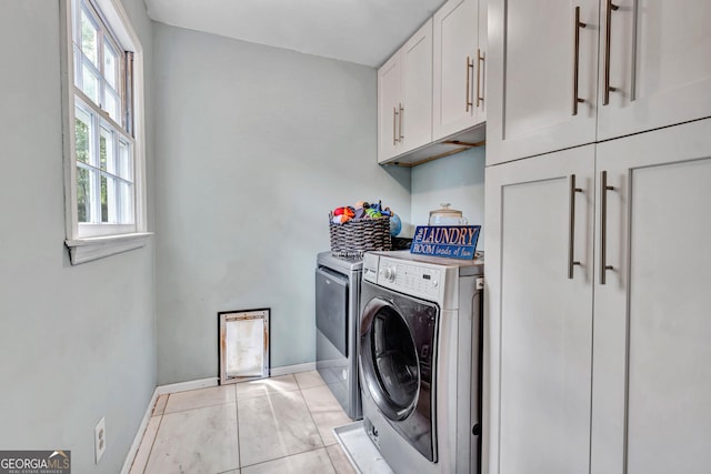 4250 Edgewater Ct NW, Kennesaw, GA 30144 - laundry area featuring cabinet space, washing machine and clothes dryer, baseboards, and light tile patterned floors