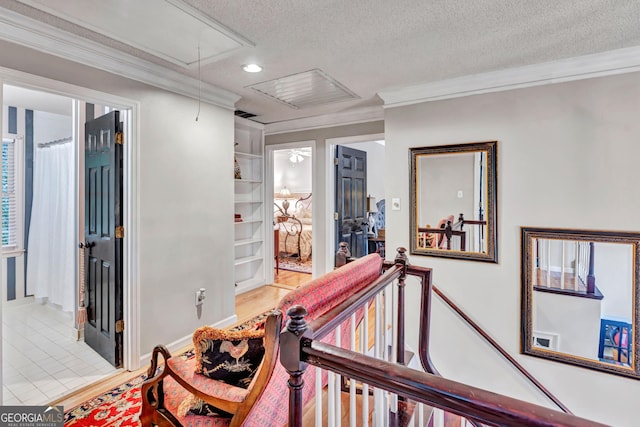 4250 Edgewater Ct NW, Kennesaw, GA 30144 - hallway with attic access, a textured ceiling, crown molding, an upstairs landing, and recessed lighting