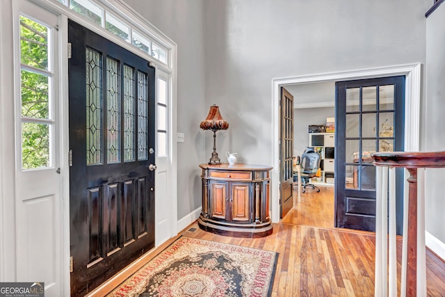 4250 Edgewater Ct NW, Kennesaw, GA 30144 - foyer with wood-type flooring, plenty of natural light, baseboards, and crown molding