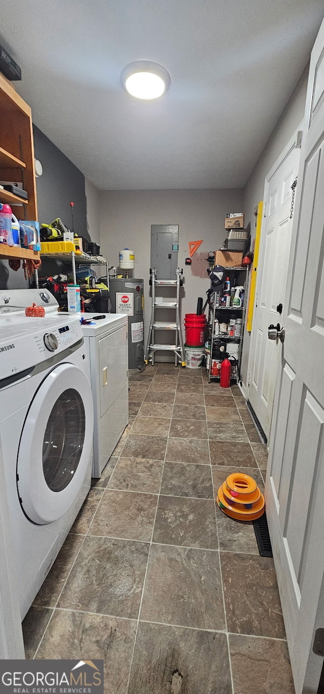 112 Hilltop Dr, Newborn, GA 30056 - laundry room featuring washing machine and clothes dryer, dark stone finish floors, electric water heater, and electric panel