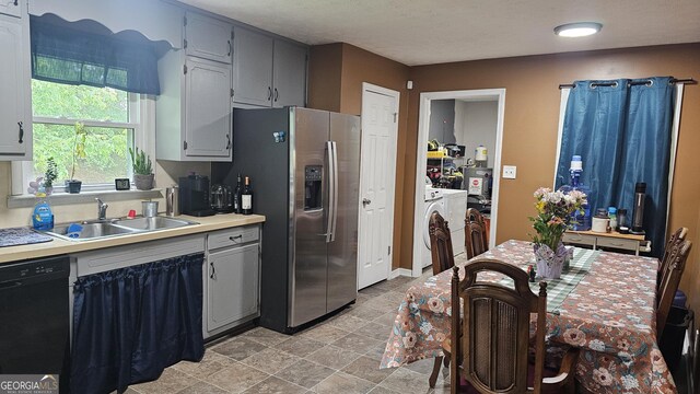 112 Hilltop Dr, Newborn, GA 30056 - kitchen with dishwasher, a sink, stainless steel refrigerator with ice dispenser, light countertops, and separate washer and dryer