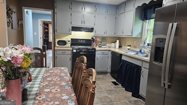 112 Hilltop Dr, Newborn, GA 30056 - kitchen with black appliances, under cabinet range hood, gray cabinets, light countertops, and a sink