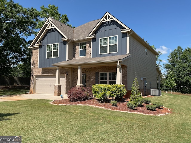 craftsman inspired home featuring board and batten siding, a garage, a front lawn, and driveway