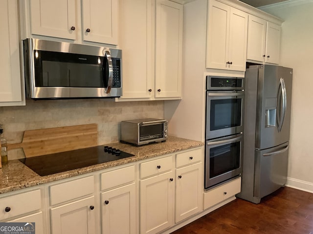 101 Elkins Blvd, Locust Grove, GA 30248 - kitchen featuring appliances with stainless steel finishes, dark wood-style flooring, white cabinets, backsplash, and light stone counters