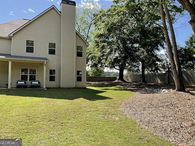 back of house with a chimney