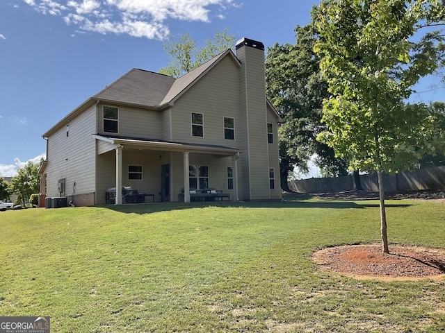 rear view of house featuring a chimney and a patio