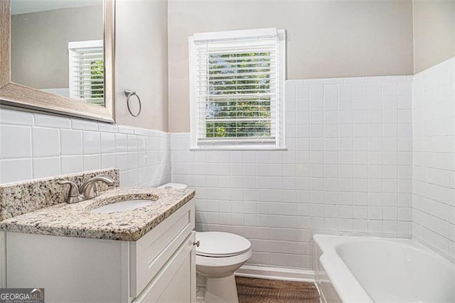 3456 Maryvale Dr, Decatur, GA 30032 - bathroom with tile walls, healthy amount of natural light, toilet, vanity, and wainscoting