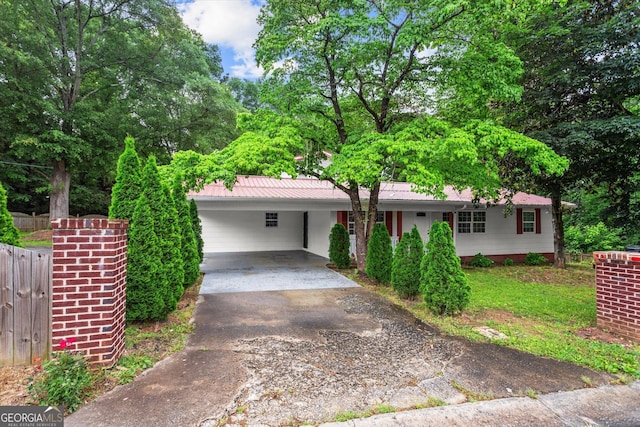 125 Sycamore Dr, Athens, GA 30606 - single story home with concrete driveway, a carport, a metal roof, and view of wooded area