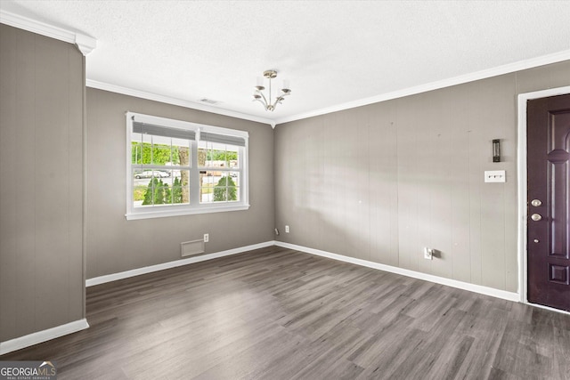 125 Sycamore Dr, Athens, GA 30606 - unfurnished room featuring dark wood-style floors, ornamental molding, a chandelier, and a textured ceiling